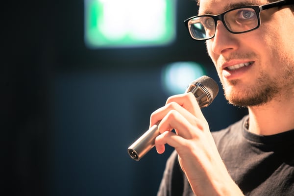 man talking in microphone - JConnelly Blog - Tech Entrepreneurs Be the Face of Your Brand