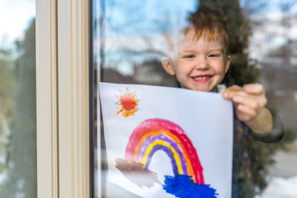 Boy Looking Out Window with Picture- JConnelly blog- Be Optimistic in Your Messaging