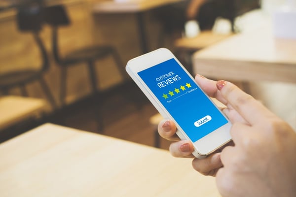Woman on cellphone- JConnelly blog- Tips for Dealing with Negative Reviews