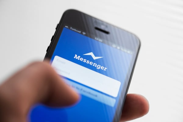 Hand on cellphone- JConnelly blog- What Messenger Apps Mean For Your Business and Why You Shouldn't Ignore Them