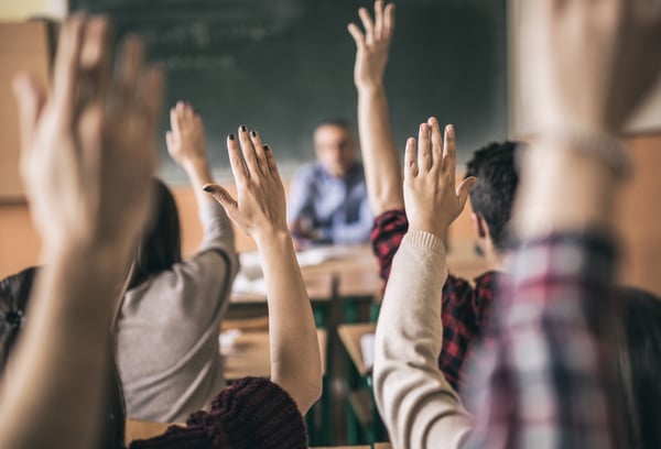 Hands raised in classroom-JConnelly blog- What You Don't Know About Financial Literacy Could Hurt You