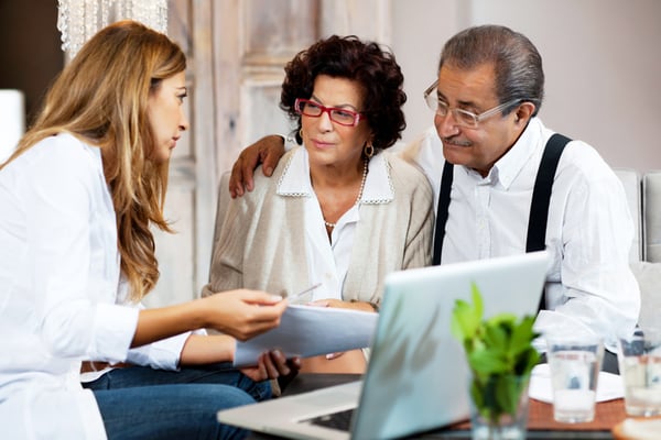 couple with financial advisor - How Financial Advisors Can Help Clients and Media Understand Volatility