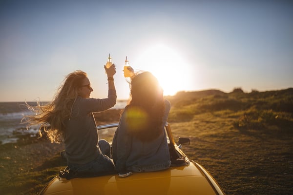 women cheering drinks on beach - JConnelly Blog- How Hard Seltzer is Changing the Malt Beverage Industry 