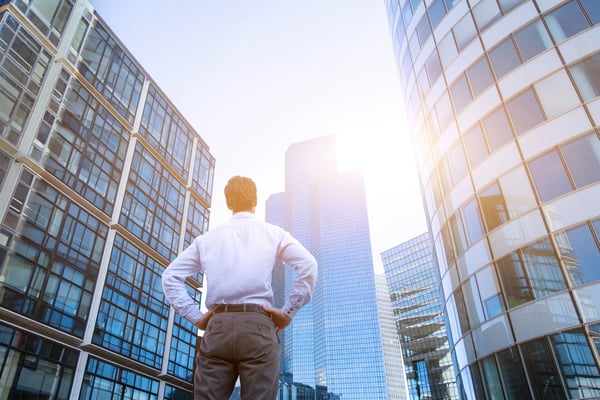 Man staring at buildings- JConnelly blog- 5 Media Tips for Breakaway Advisors